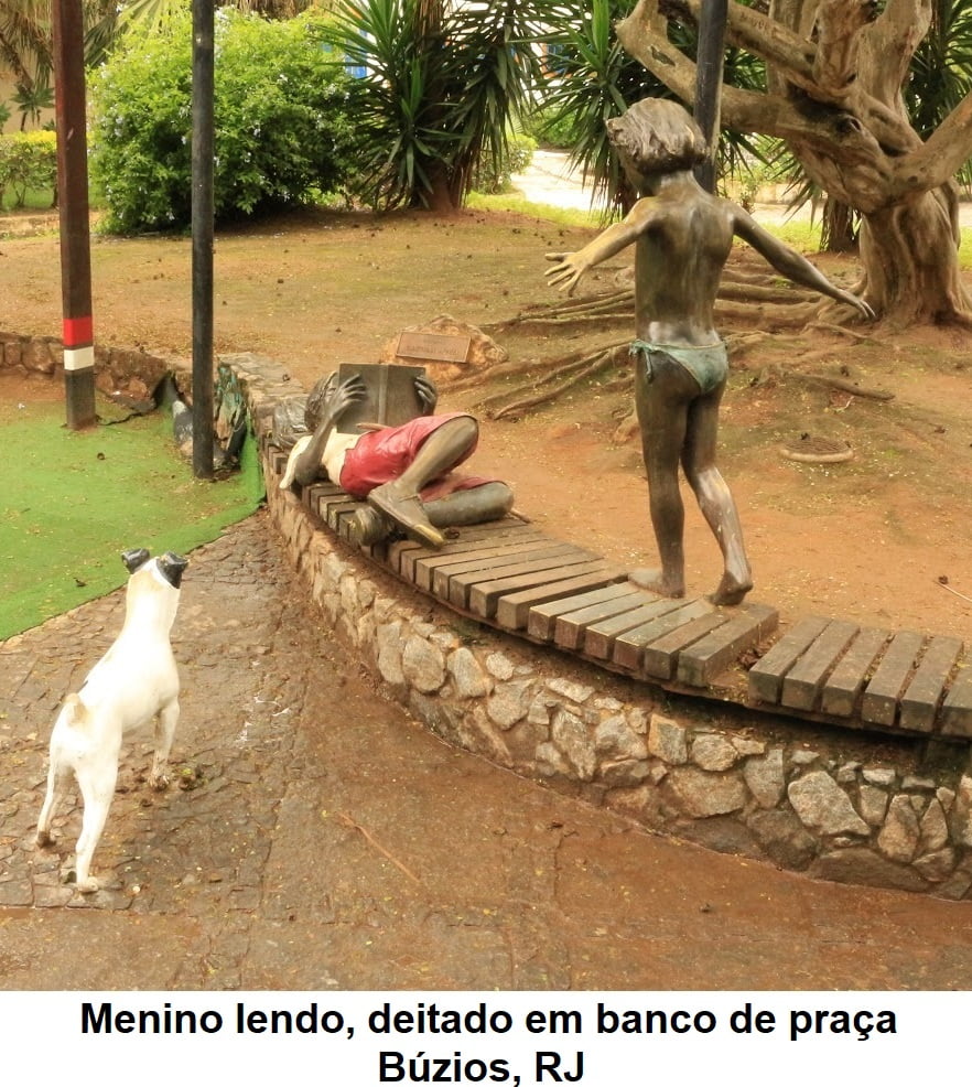 Menino lendo, deitado em banco de praça - Búzios, RJ